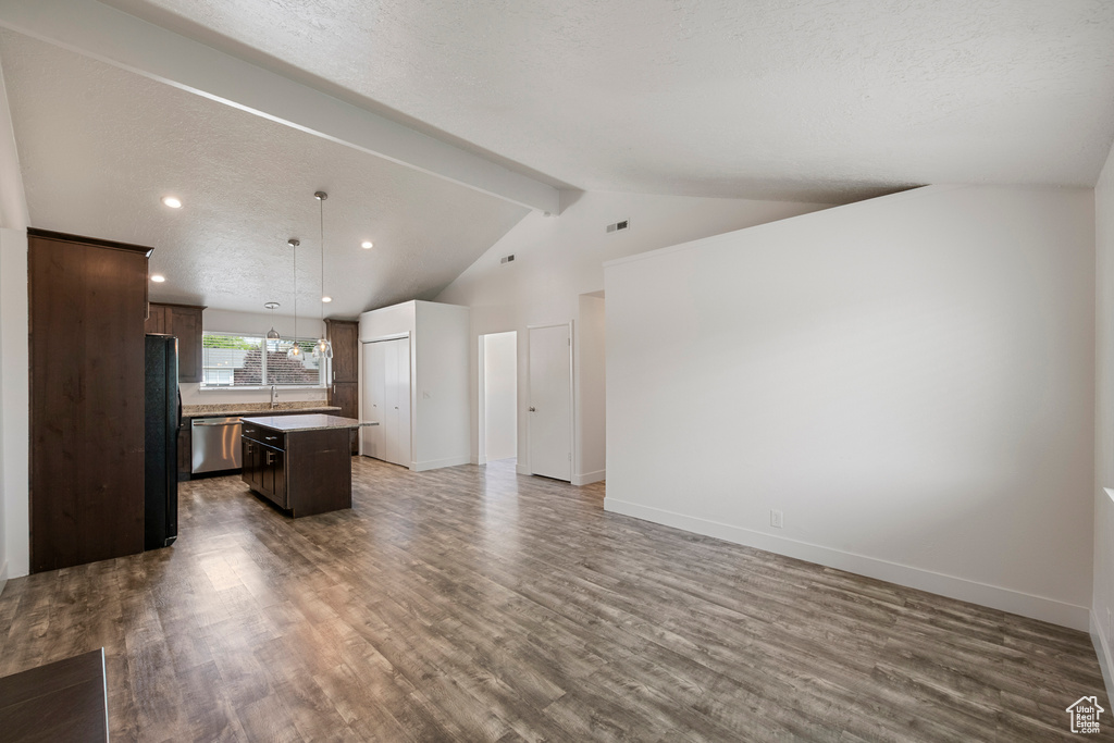 Unfurnished living room featuring wood finished floors, a sink, baseboards, and recessed lighting