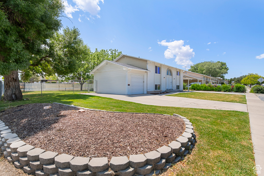 View of front of property with driveway and an attached garage