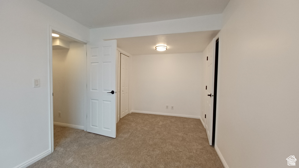 Empty room featuring carpet flooring and baseboards