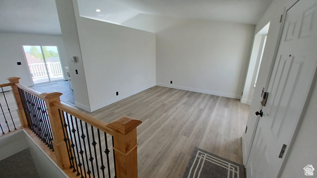 Interior space with light wood-style flooring and vaulted ceiling