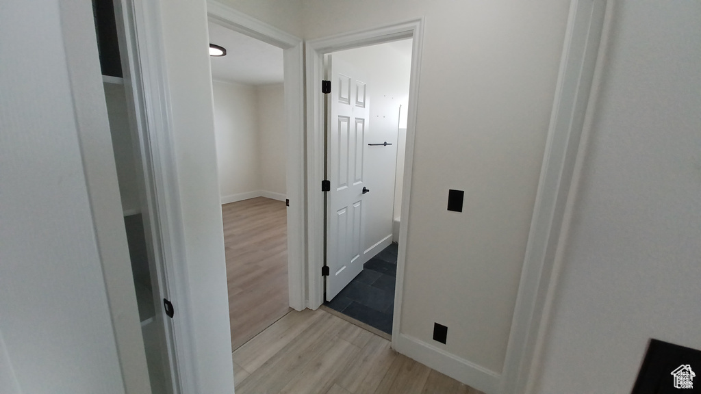 Hall featuring light wood finished floors and baseboards