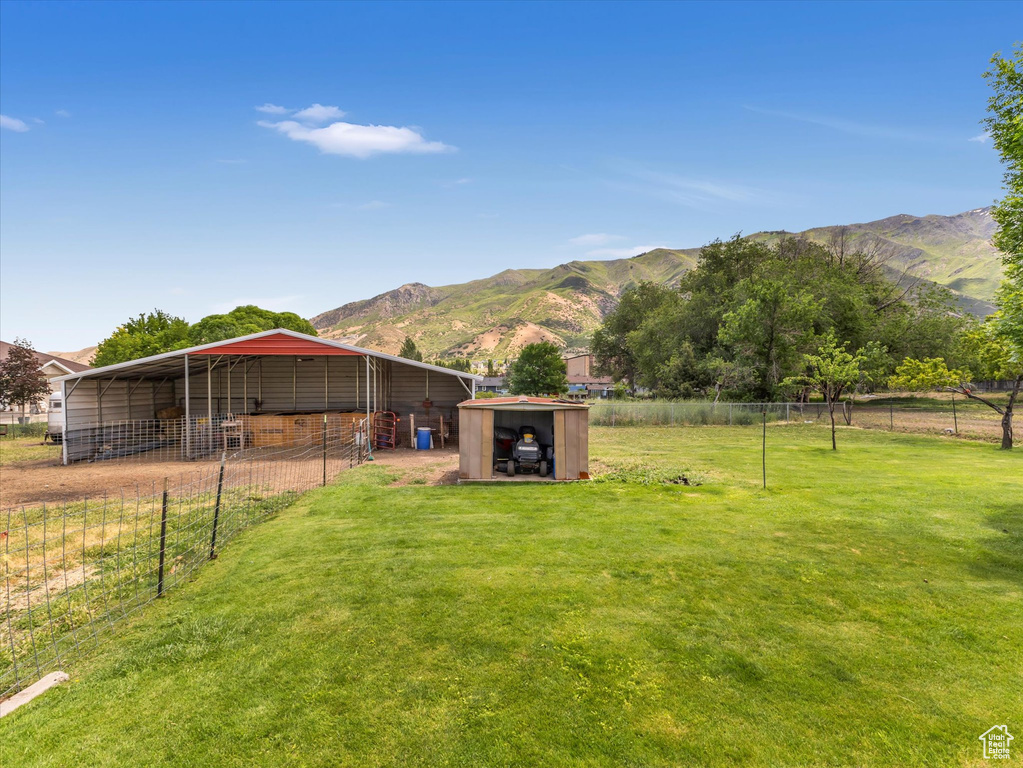 View of yard with a mountain view and an outbuilding