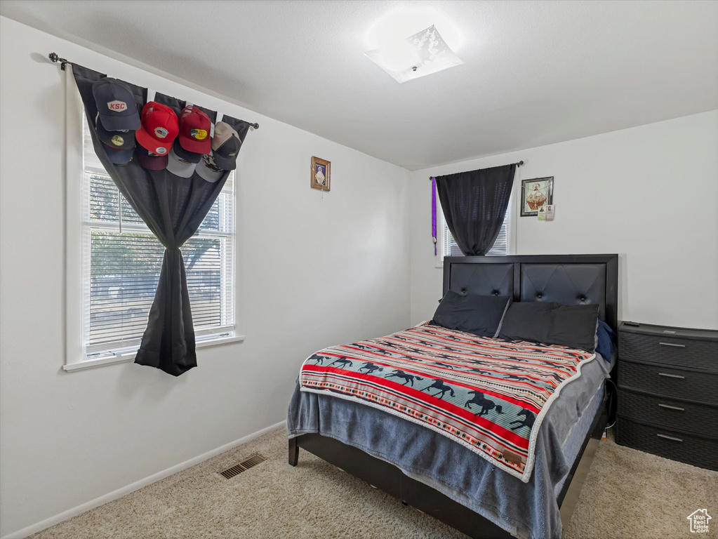 Carpeted bedroom with baseboards