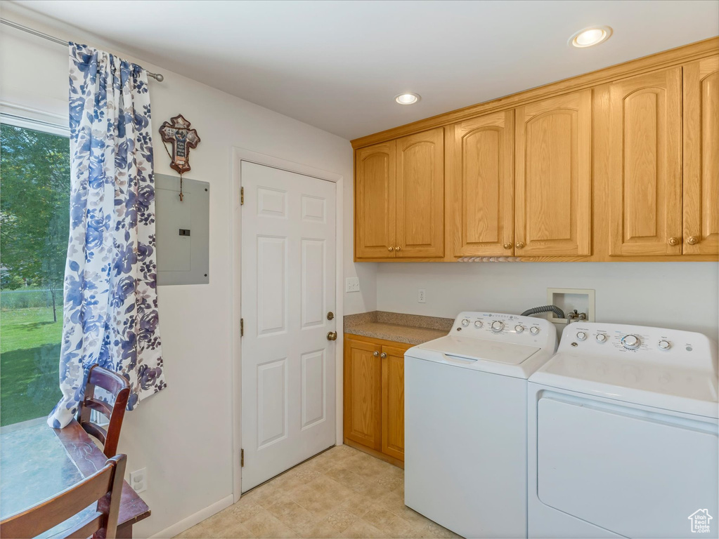 Washroom featuring electric panel, independent washer and dryer, cabinet space, and recessed lighting