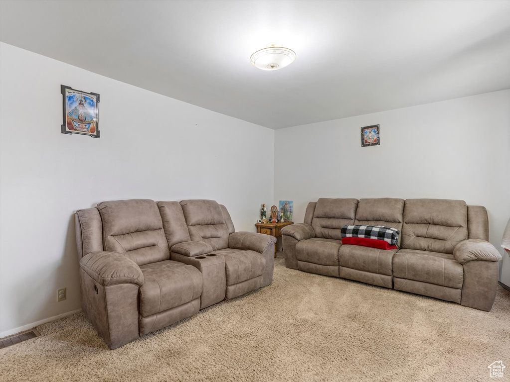 Carpeted living room with baseboards