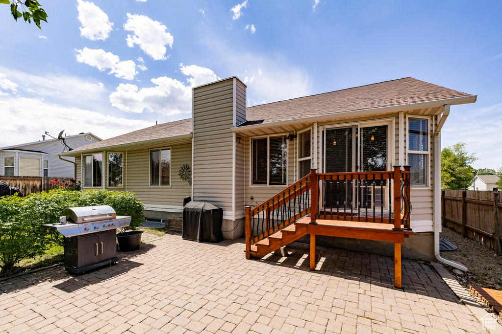 Back of house featuring a patio area and a chimney