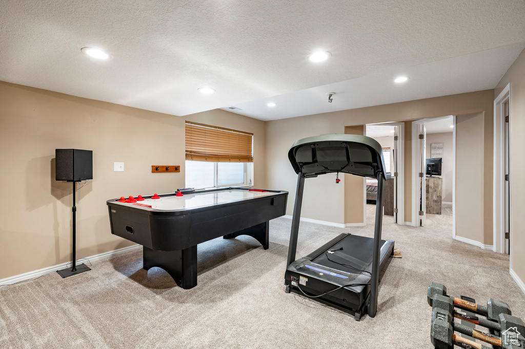 Game room with light carpet, a textured ceiling, and recessed lighting