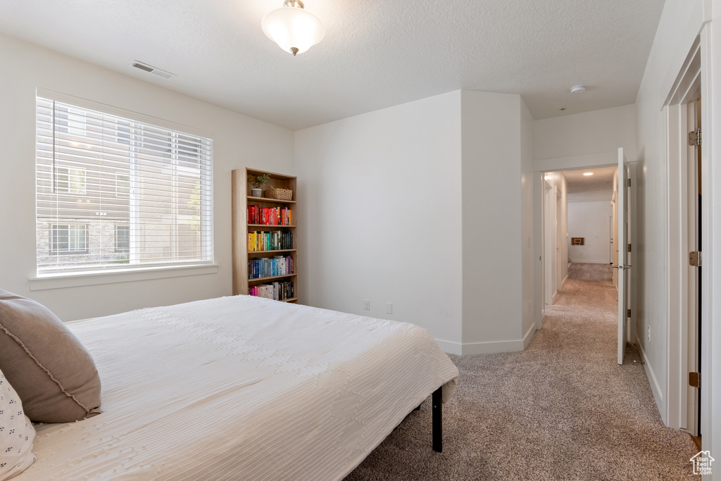 Carpeted bedroom with baseboards