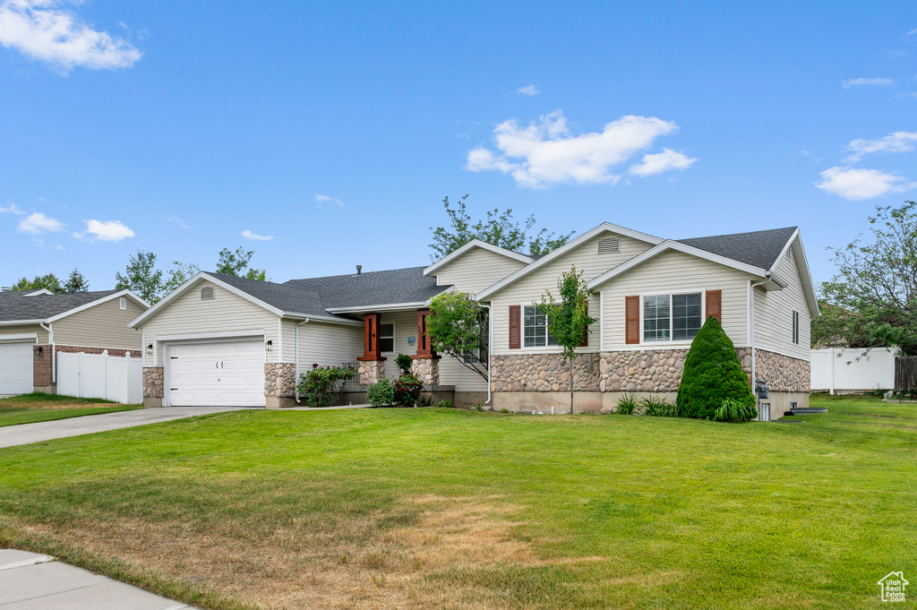 Ranch-style home featuring stone siding, driveway, a garage, and a shingled roof