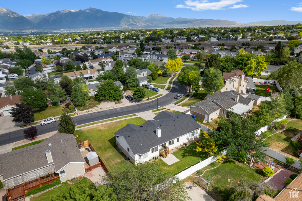 Aerial view of property\'s location featuring nearby suburban area and a mountain backdrop