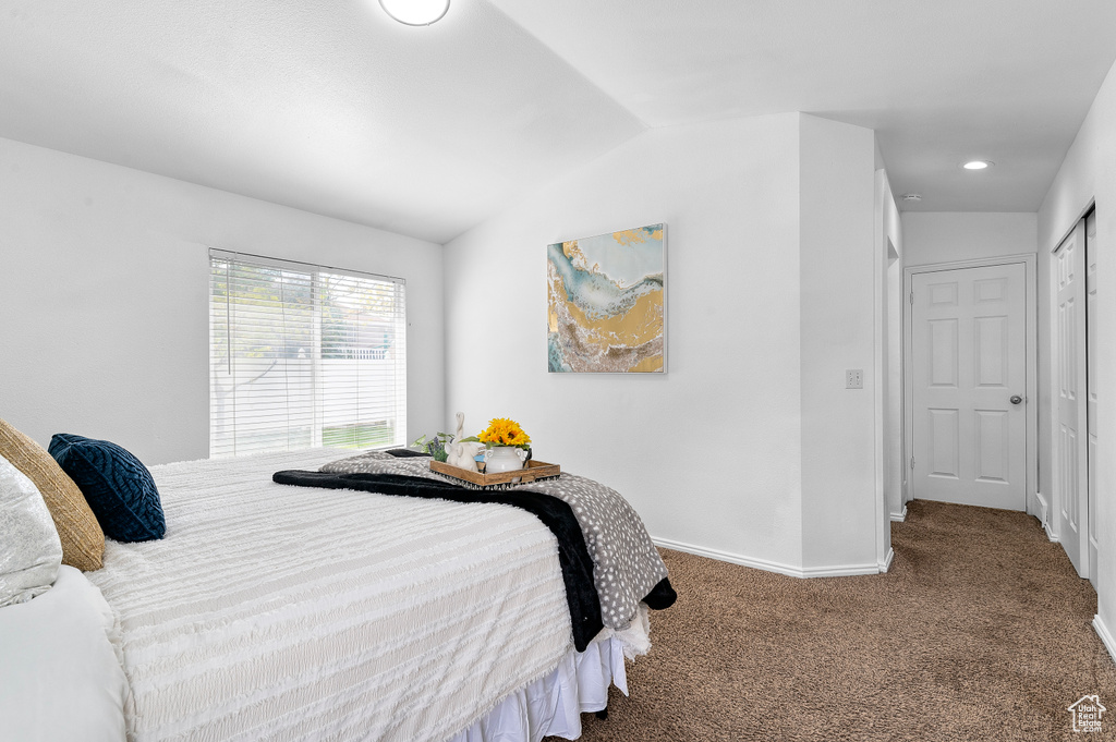 Carpeted bedroom featuring lofted ceiling and recessed lighting