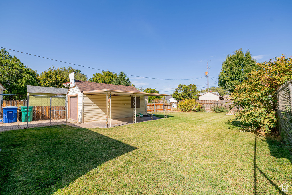View of yard featuring an outdoor structure and a patio area
