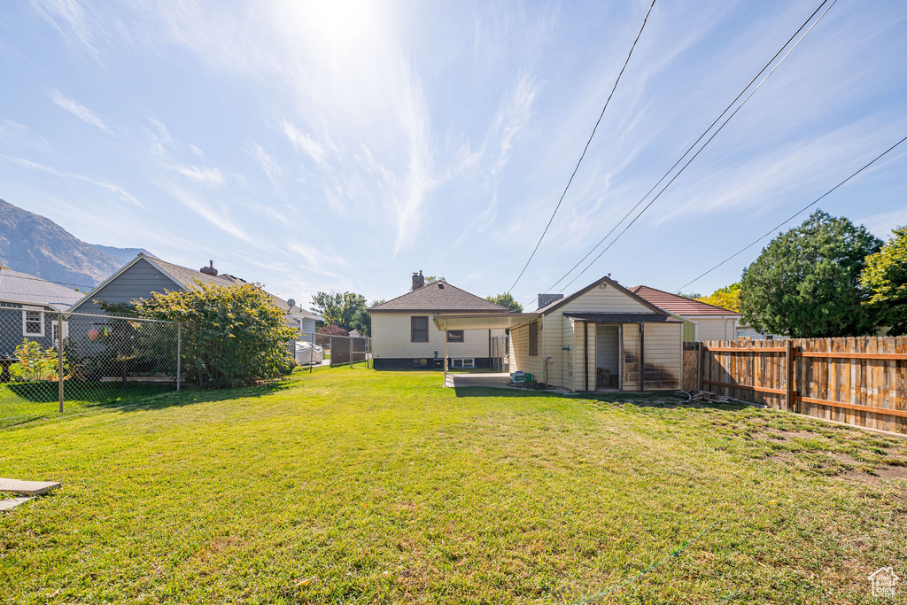 Back of property featuring an outdoor structure