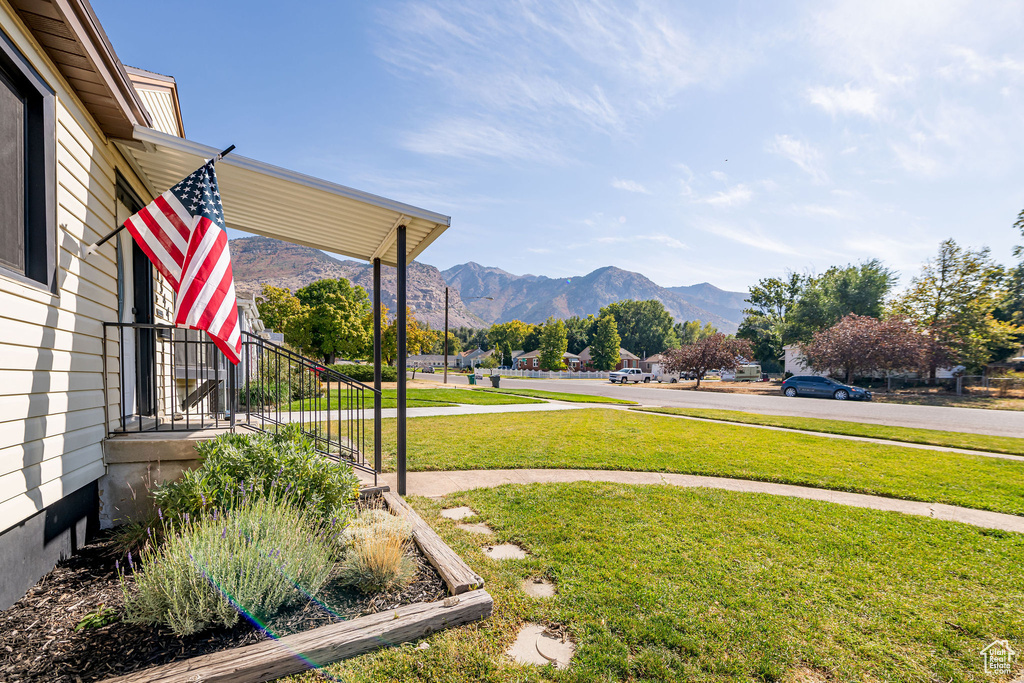 View of grassy yard with a mountain view