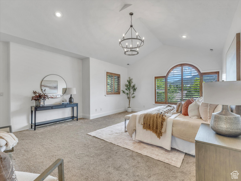 Carpeted bedroom featuring a chandelier, recessed lighting, and high vaulted ceiling