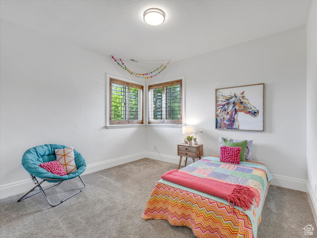 Carpeted bedroom featuring baseboards