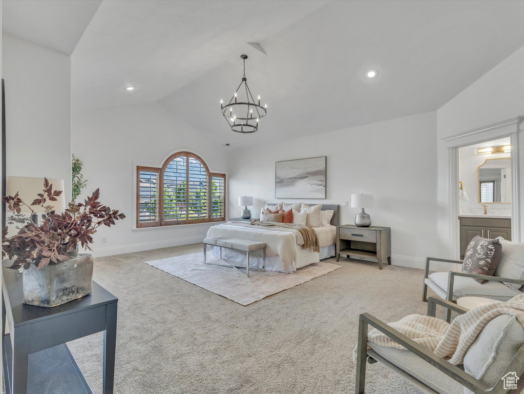 Carpeted bedroom with a chandelier, recessed lighting, and high vaulted ceiling