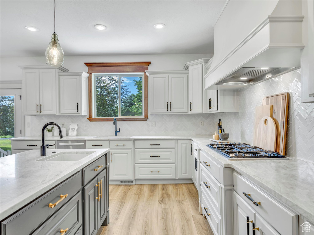 Kitchen featuring premium range hood, gray cabinetry, white cabinetry, pendant lighting, and recessed lighting