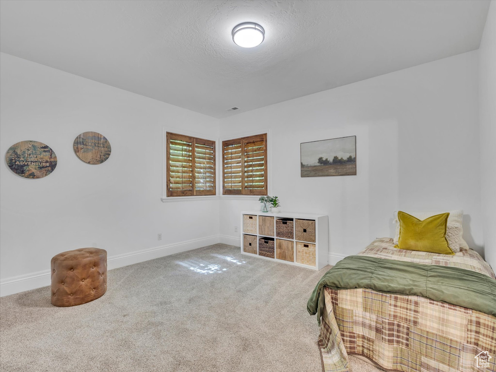 Carpeted bedroom featuring baseboards