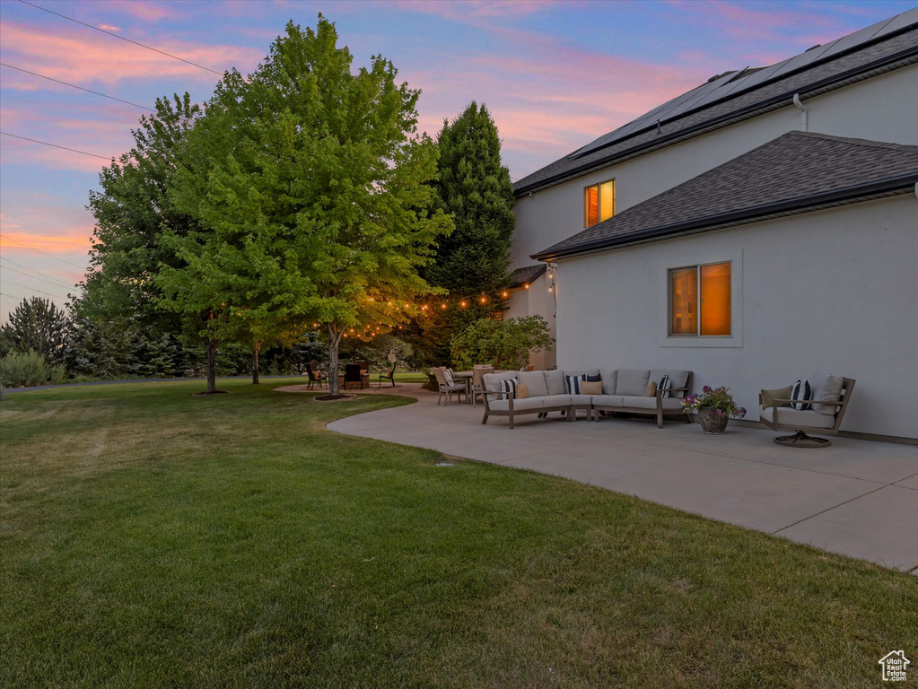 Yard at dusk featuring an outdoor hangout area, a yard, and a patio