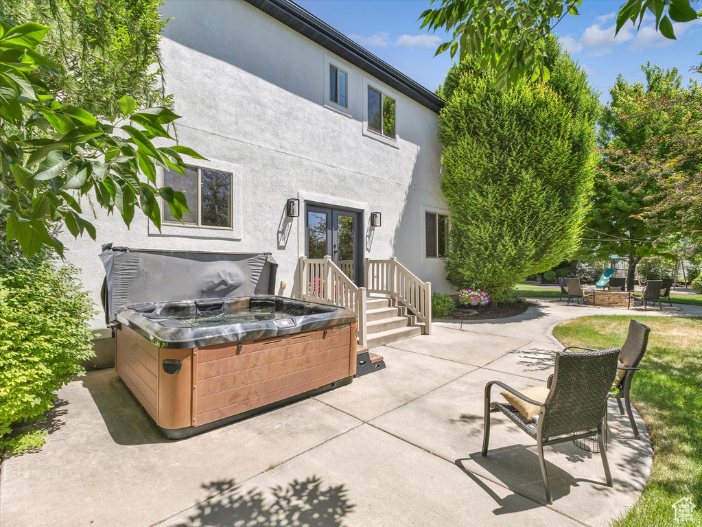 View of patio featuring french doors and a hot tub