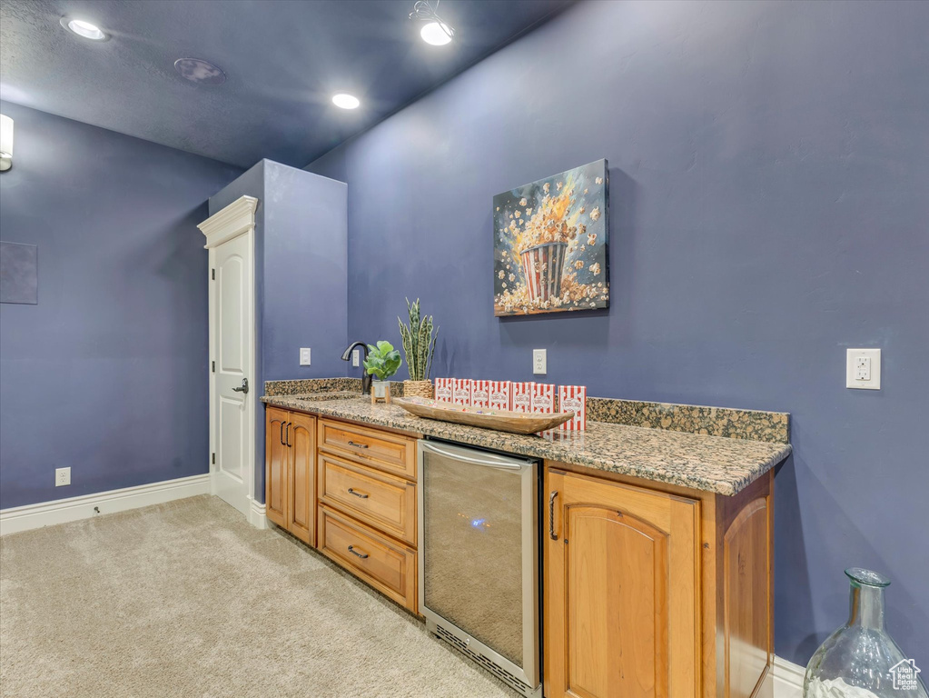 Bar area featuring beverage cooler, light colored carpet, and recessed lighting