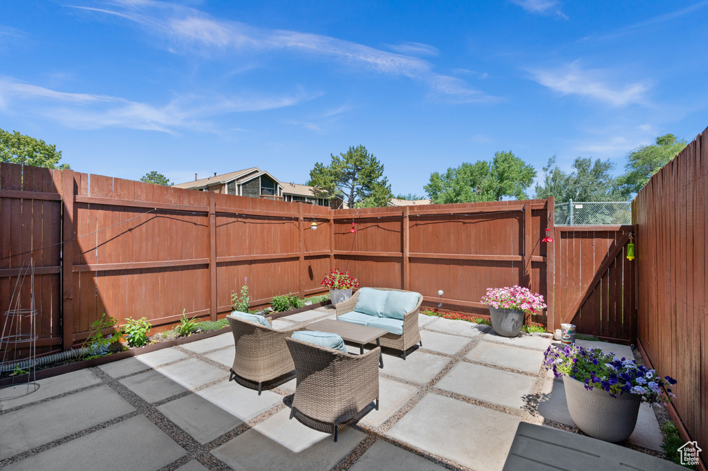 Fenced backyard with a patio area, outdoor lounge area, and a gate