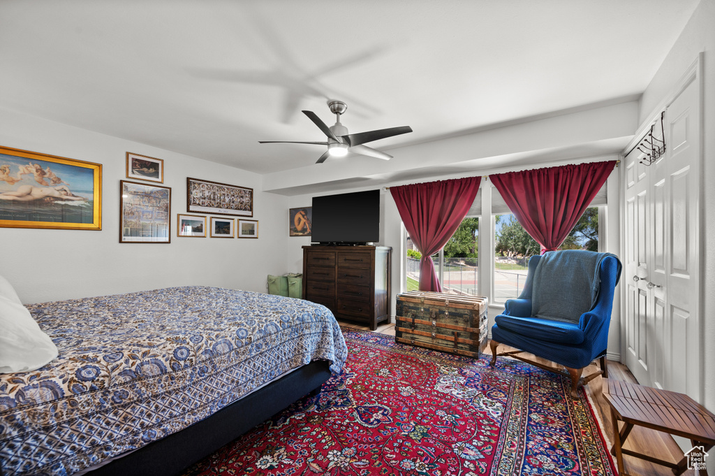 Bedroom with ceiling fan and wood finished floors