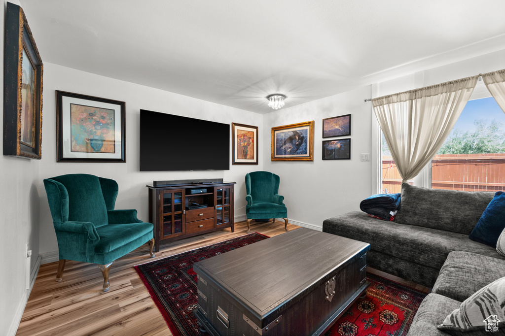 Living area with baseboards and wood finished floors