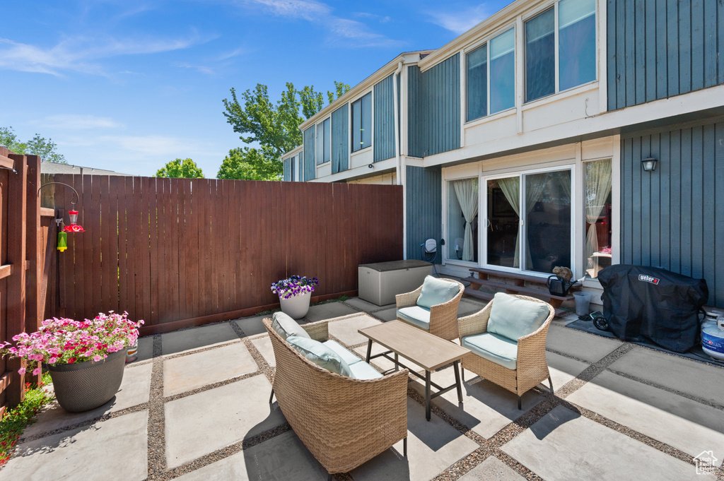 Fenced backyard featuring a patio and outdoor lounge area