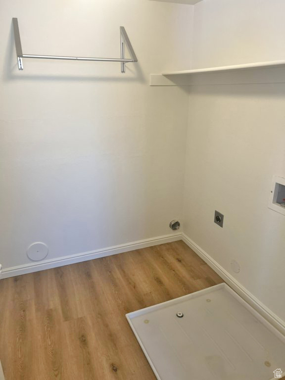 Laundry area with wood finished floors, hookup for an electric dryer, and washer hookup