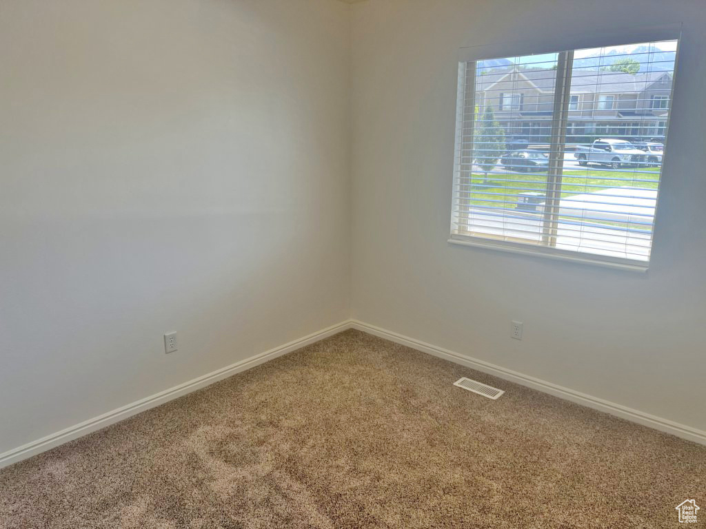 Carpeted empty room with healthy amount of natural light