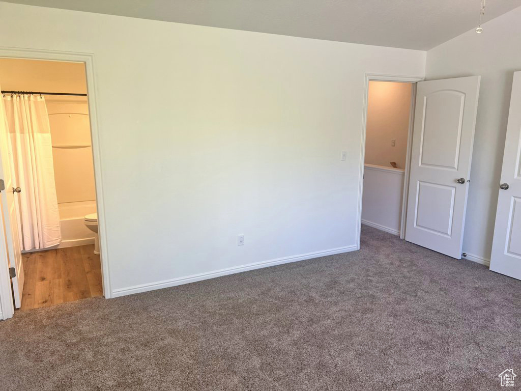Unfurnished bedroom featuring carpet and baseboards