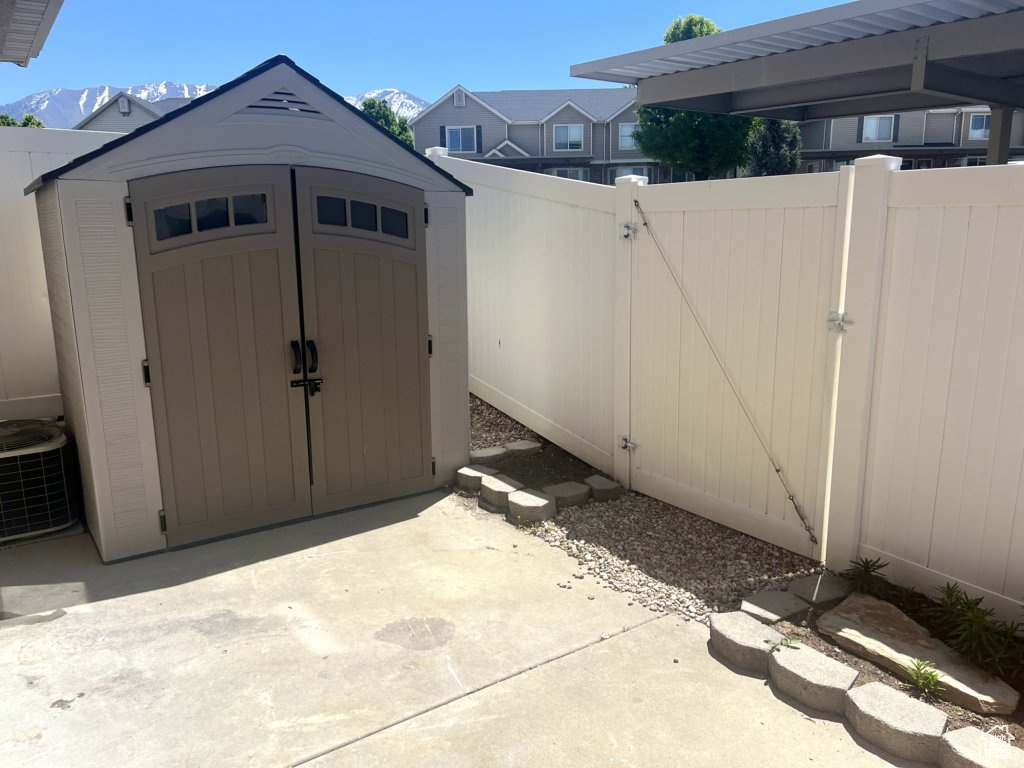 View of shed with a gate and a mountain view