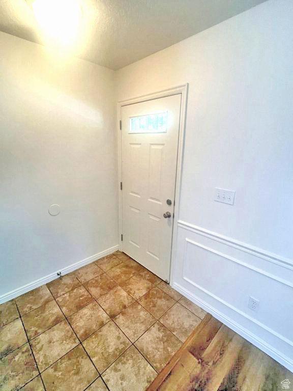 Doorway to outside with baseboards