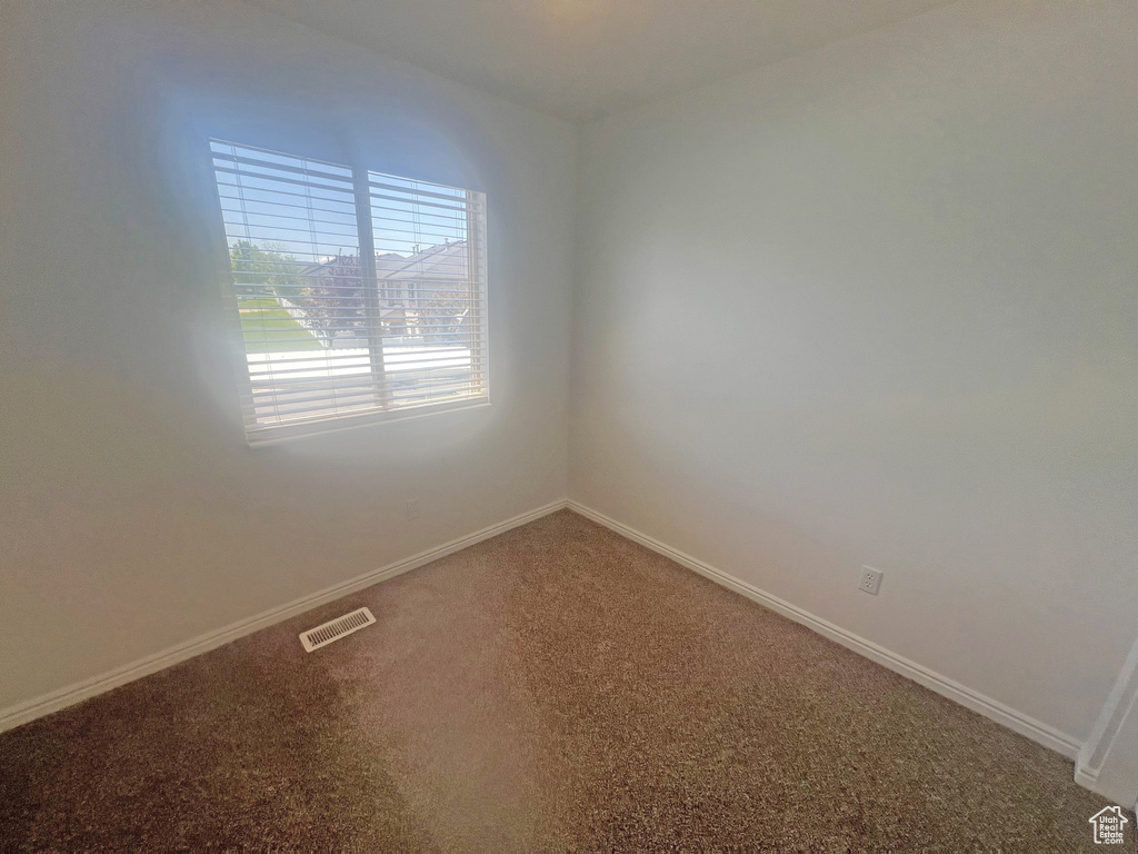Unfurnished room featuring carpet flooring and baseboards