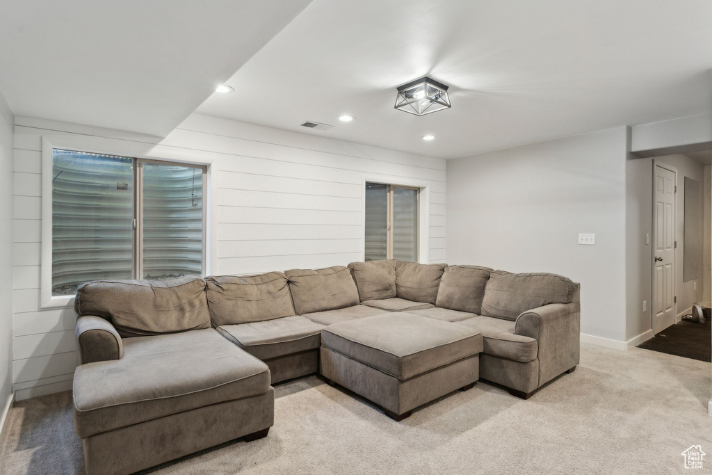 Living room with recessed lighting, light carpet, and baseboards