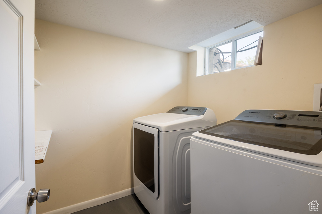 Laundry room with washer and dryer and baseboards