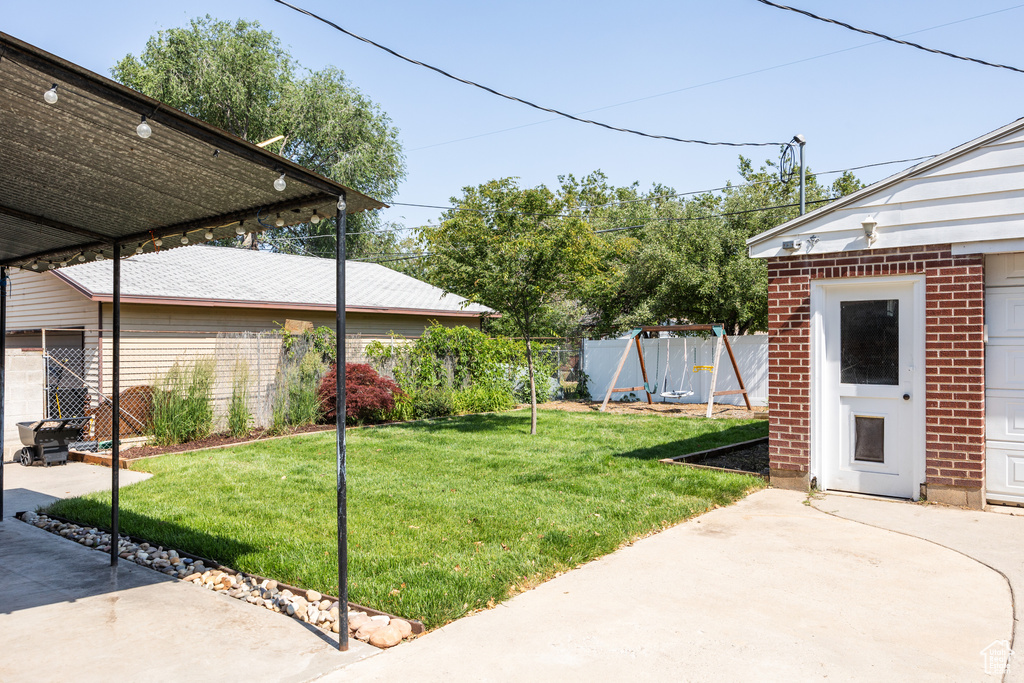 View of yard with a patio and a playground