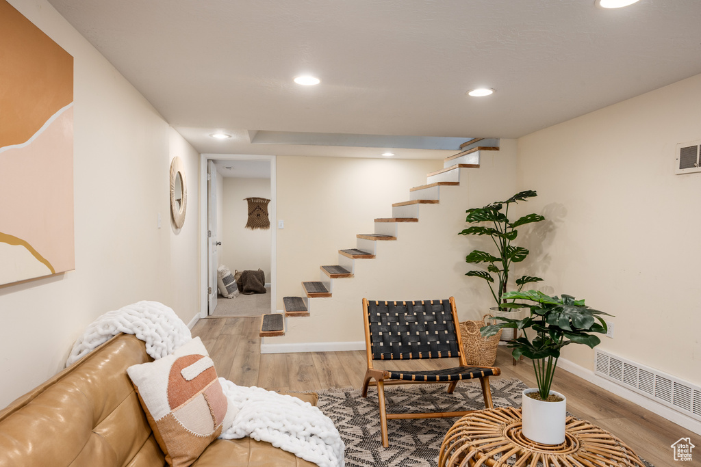 Living area featuring recessed lighting, wood finished floors, and stairs