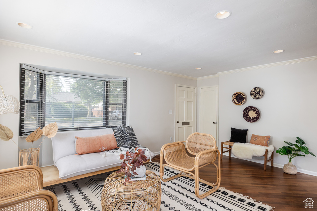 Living area featuring wood finished floors, recessed lighting, and ornamental molding