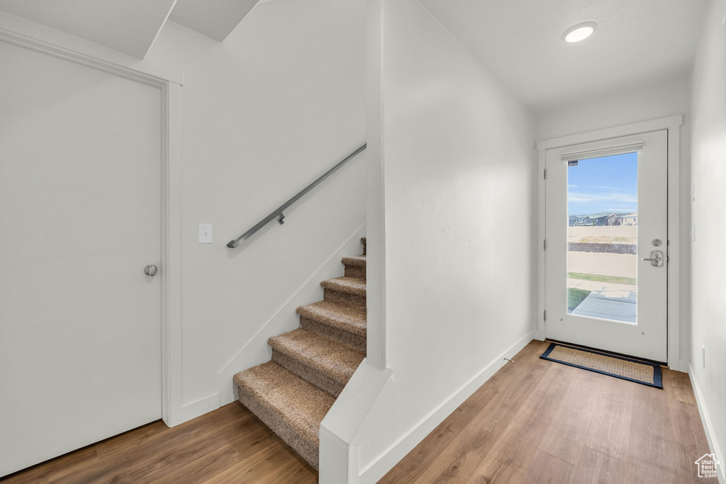 Foyer featuring light wood-style floors and stairs