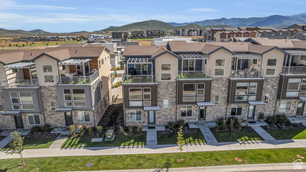 View of property with a mountain view and a residential view