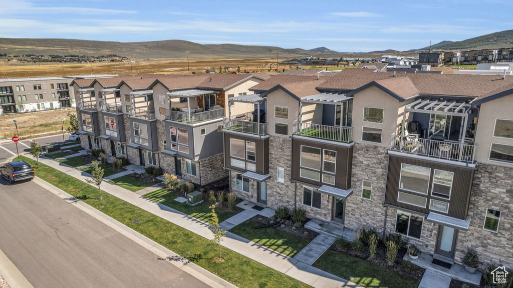 View of property featuring a mountain view and a residential view