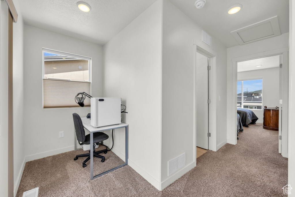 Carpeted home office with recessed lighting and attic access
