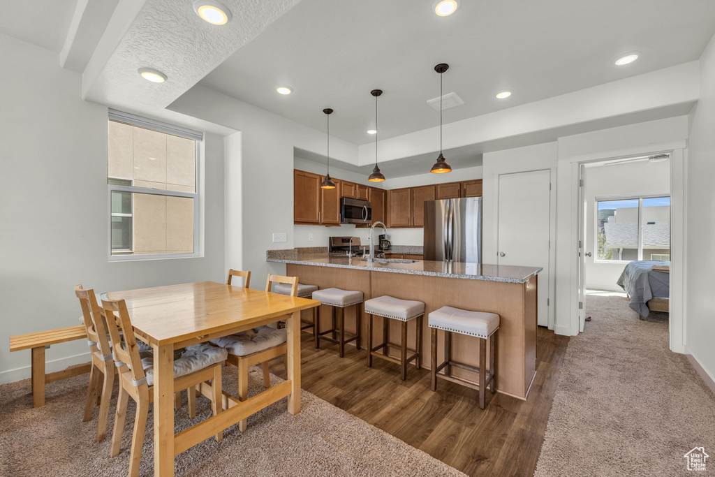 Dining area with recessed lighting and dark wood-style flooring
