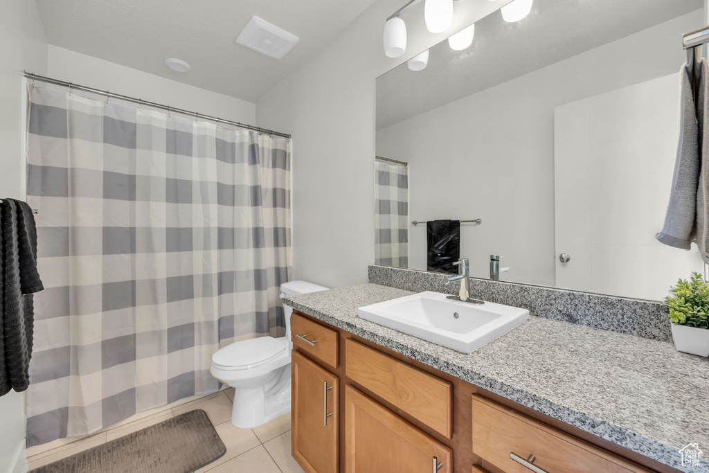 Full bath featuring vanity and tile patterned flooring