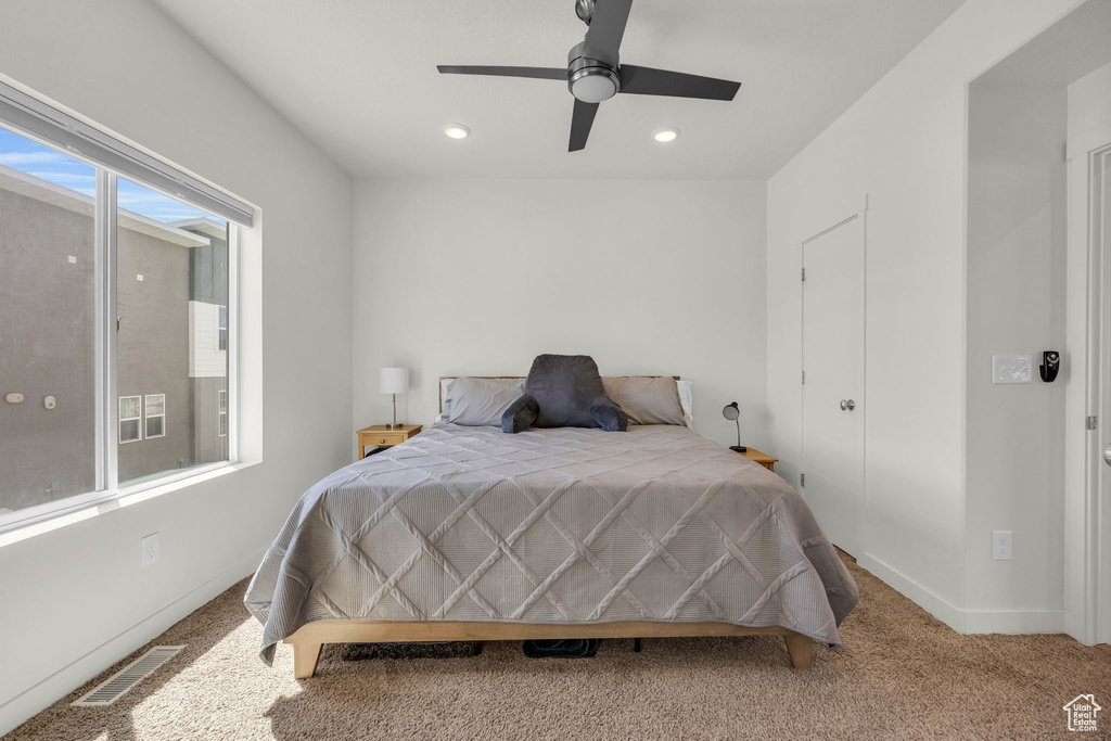 Carpeted bedroom with recessed lighting and ceiling fan