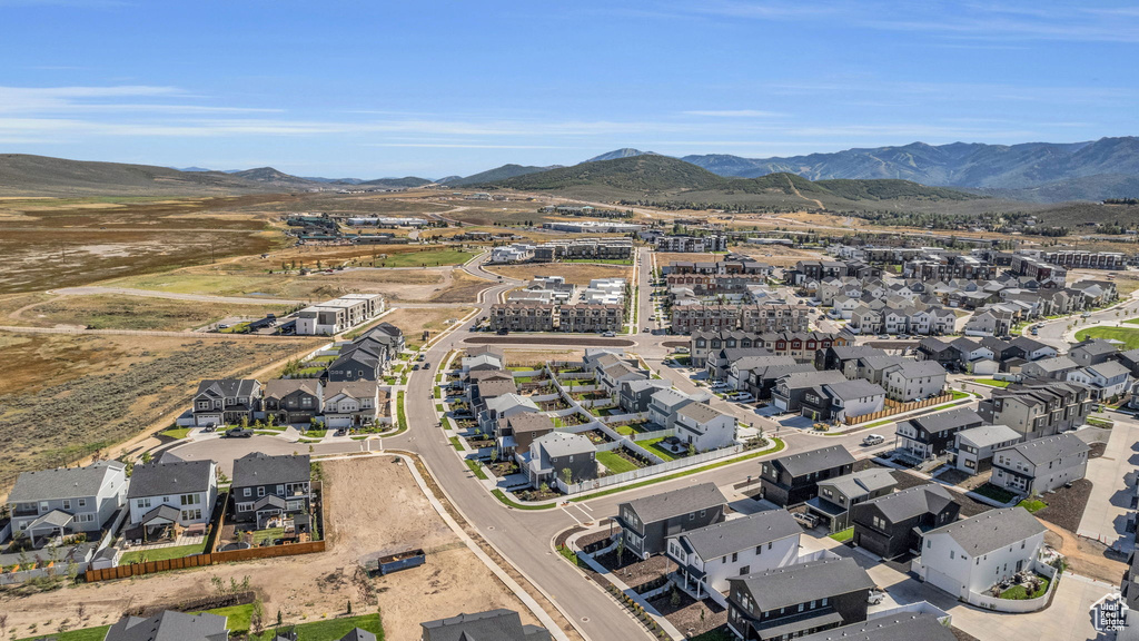Aerial view of property's location with nearby suburban area and a mountain backdrop