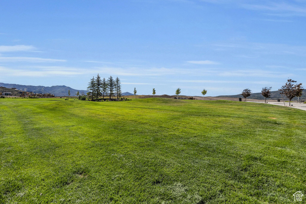 View of grassy yard featuring a view of countryside and a mountain view